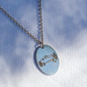 Sterling silver charm necklace with a personalized laser engraving of a mountain peak