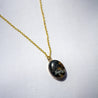 A stone pendant necklace made with natural granite and 14k gold fill